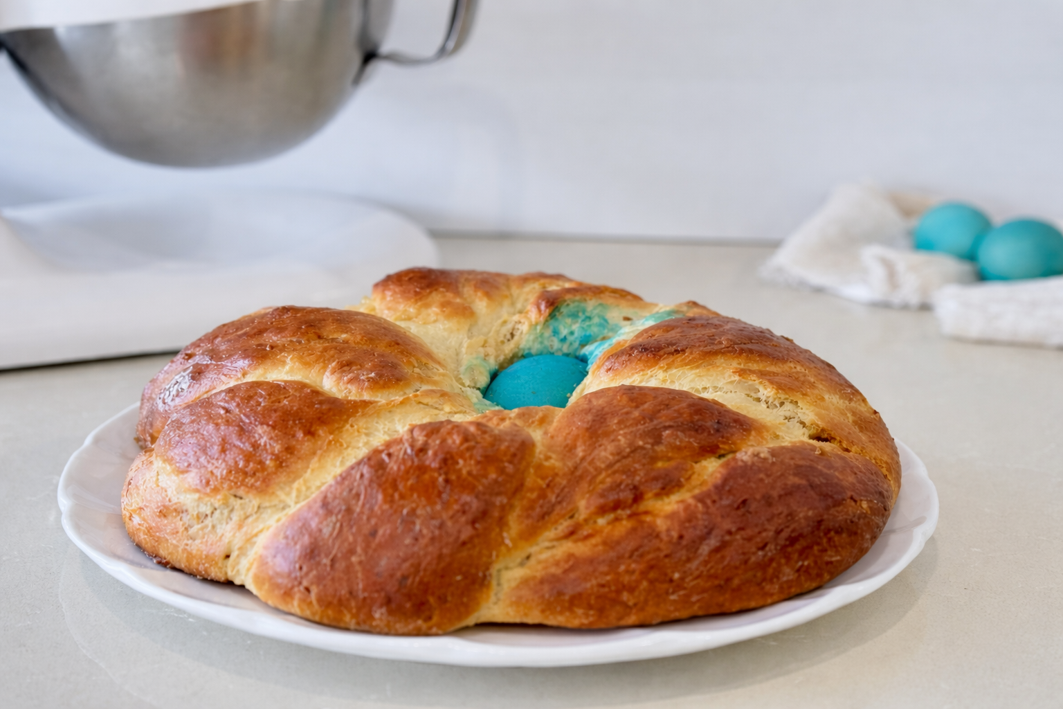 Golden Portuguese Easter bread (Folar da Páscoa) with a colored egg.