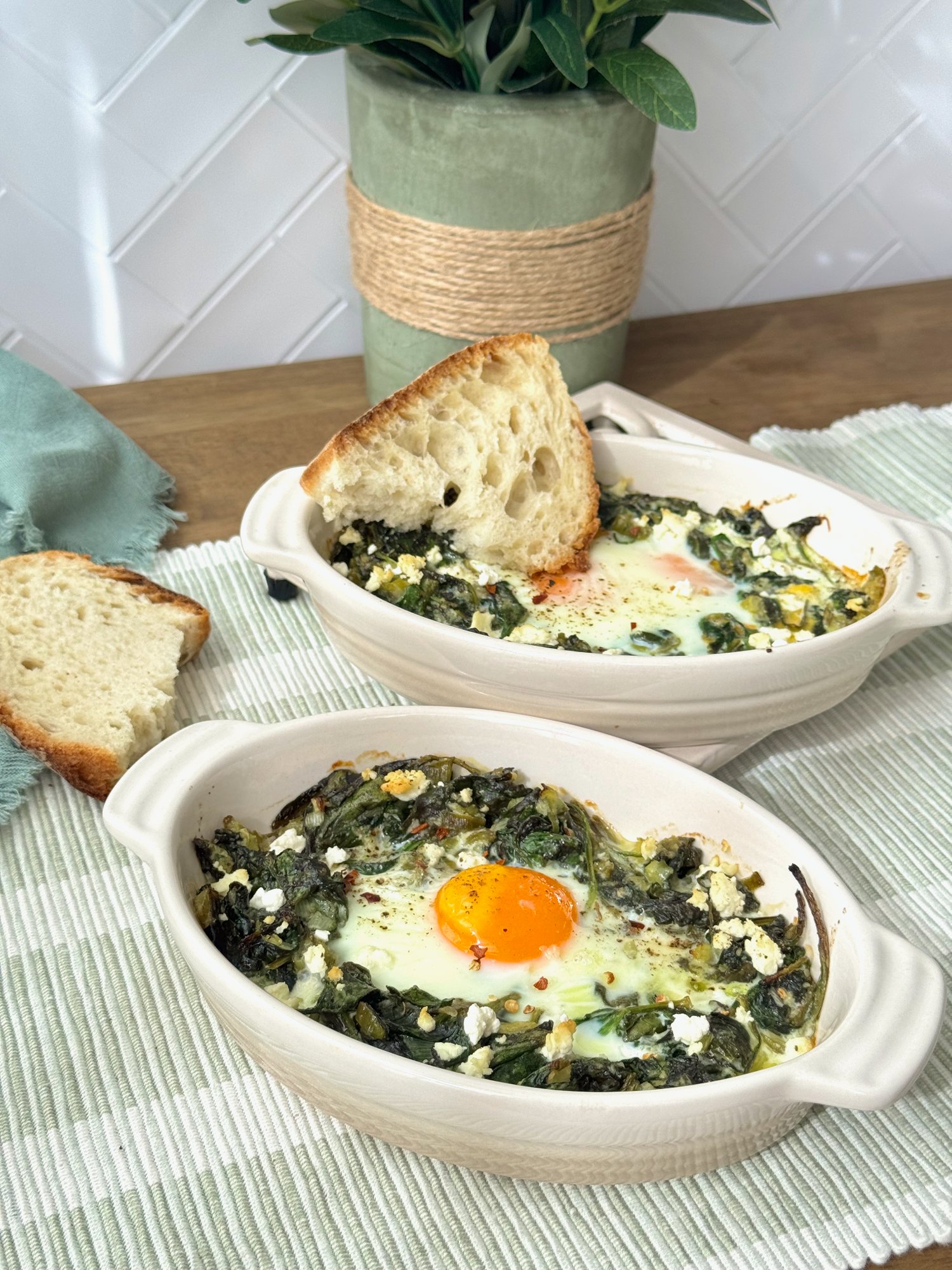 Baked eggs nestled in garlicky spinach with crumbled feta, spring onion and chilli flakes.