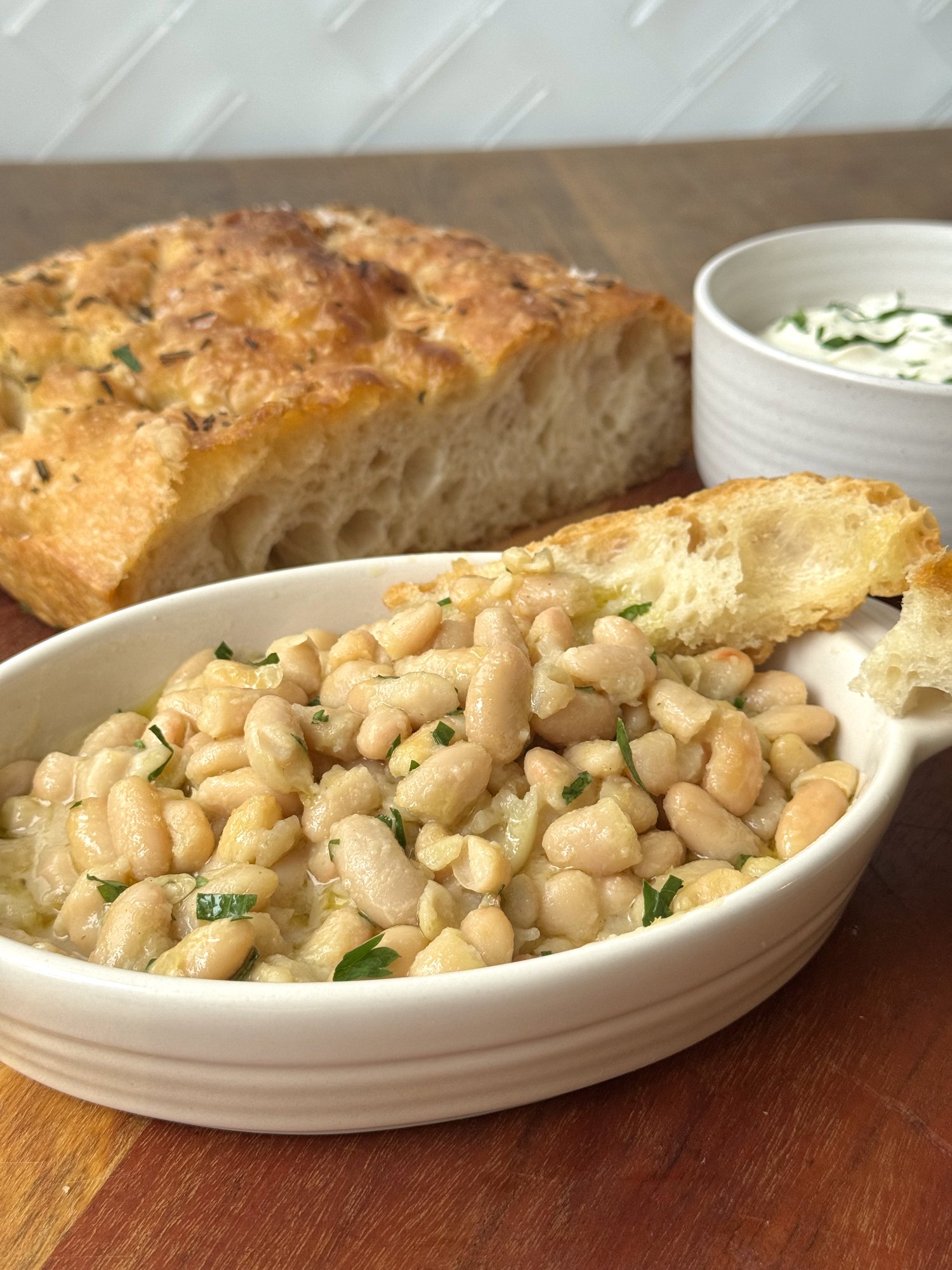 Warm cannellini beans with garlic and olive oil, served with torn focaccia.