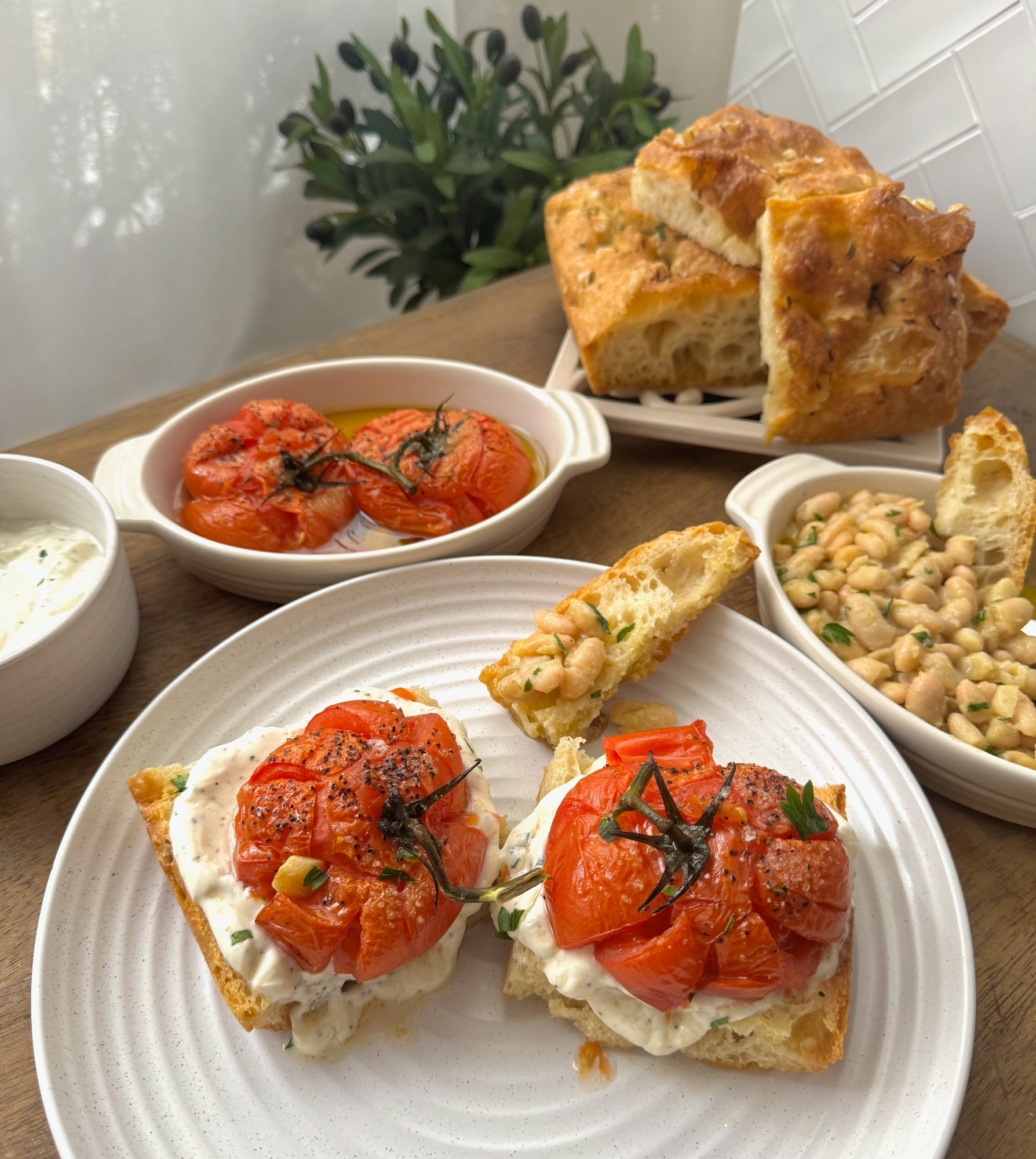 Focaccia topped with whipped ricotta, feta and soft roasted vine tomatoes.