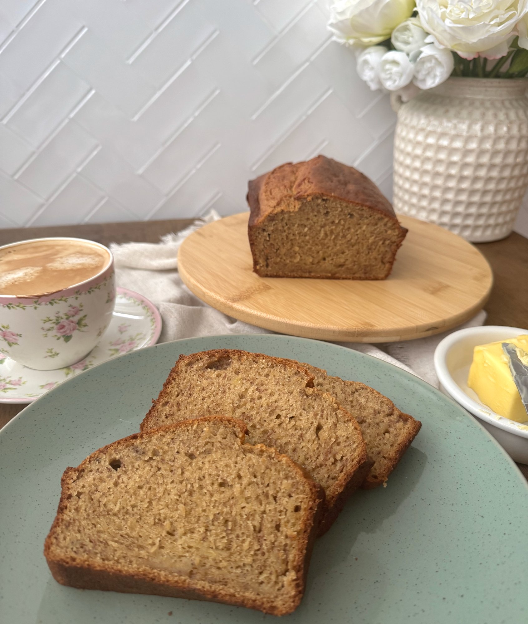 A sliced banana loaf showing its soft, moist crumb.