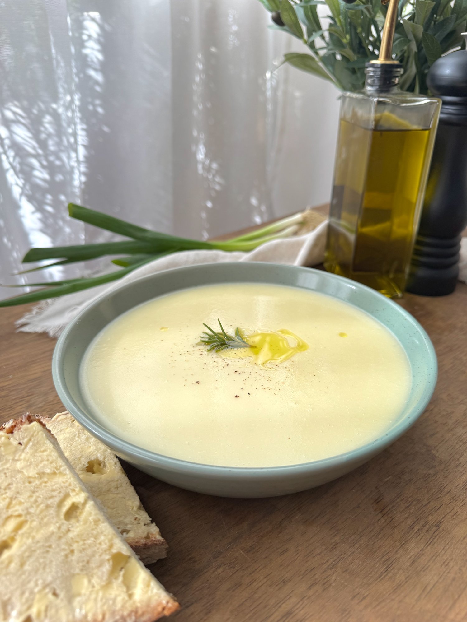 A bowl of smooth, creamy potato and leek soup.