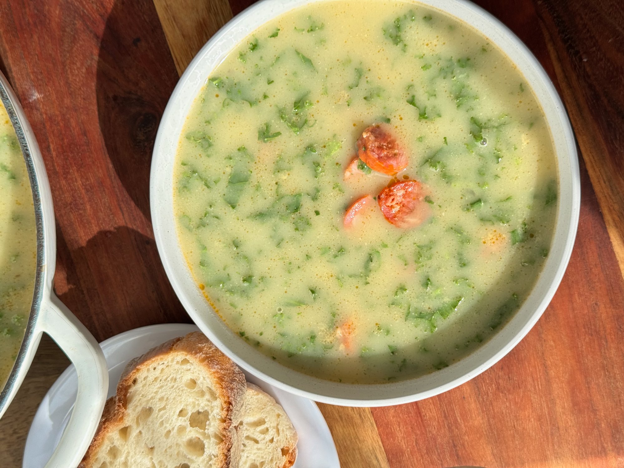 A bowl of caldo verde, Portuguese potato soup with finely sliced kale and chouriço.