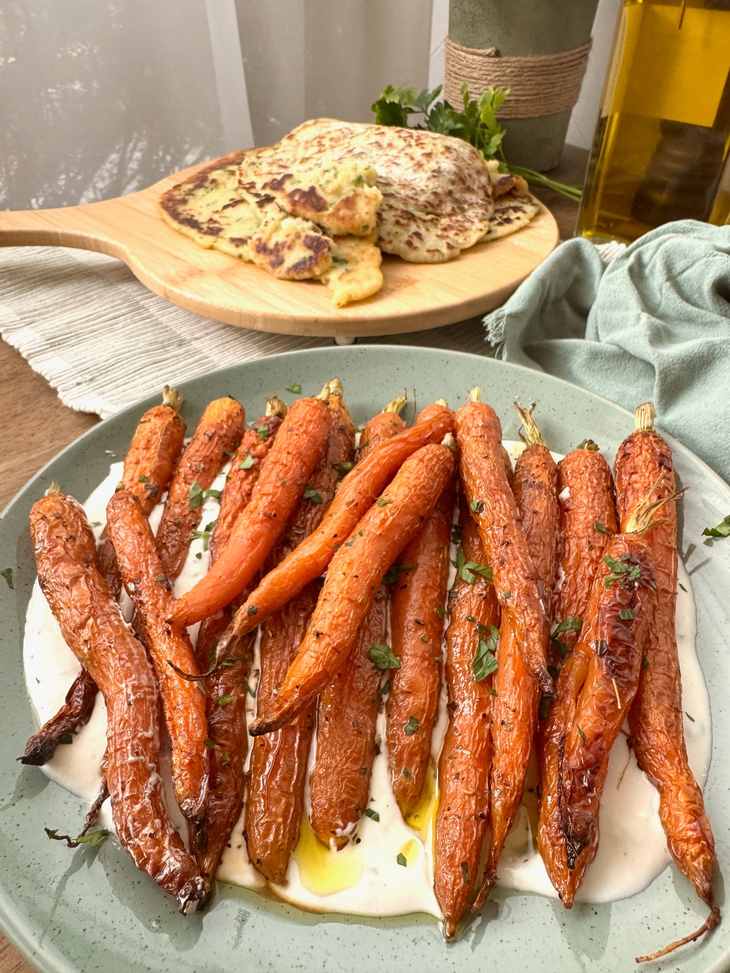 Roasted baby carrots over a creamy ricotta yoghurt base with fresh herbs and olive oil.