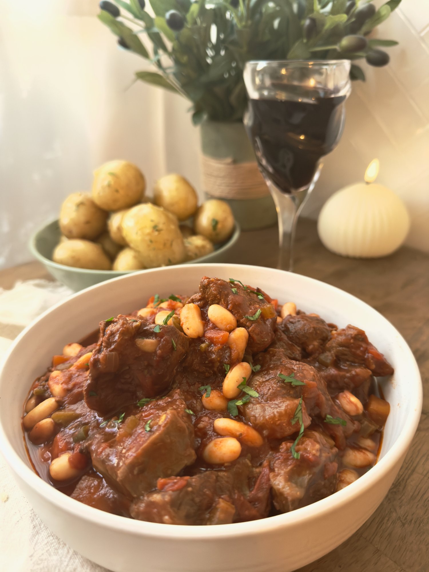 Slow beef stew with tender beef chunks and cannellini beans in a rich tomato sauce.