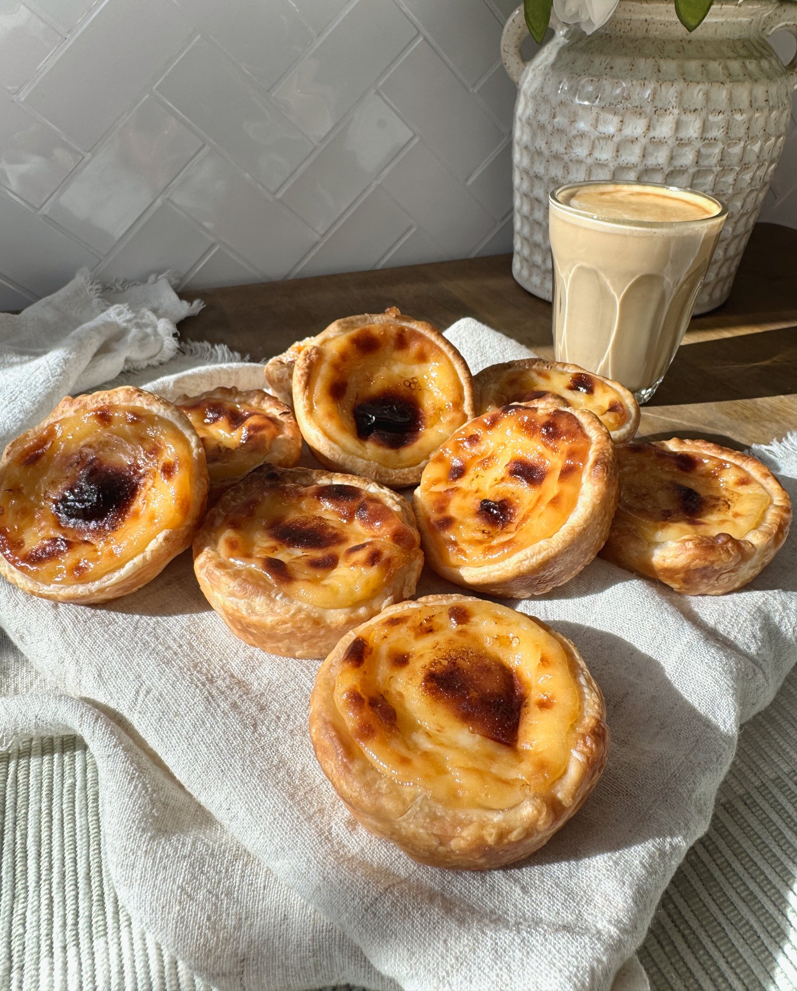 Pastéis de nata, Portuguese custard tarts with flaky spiral pastry and caramelised tops.