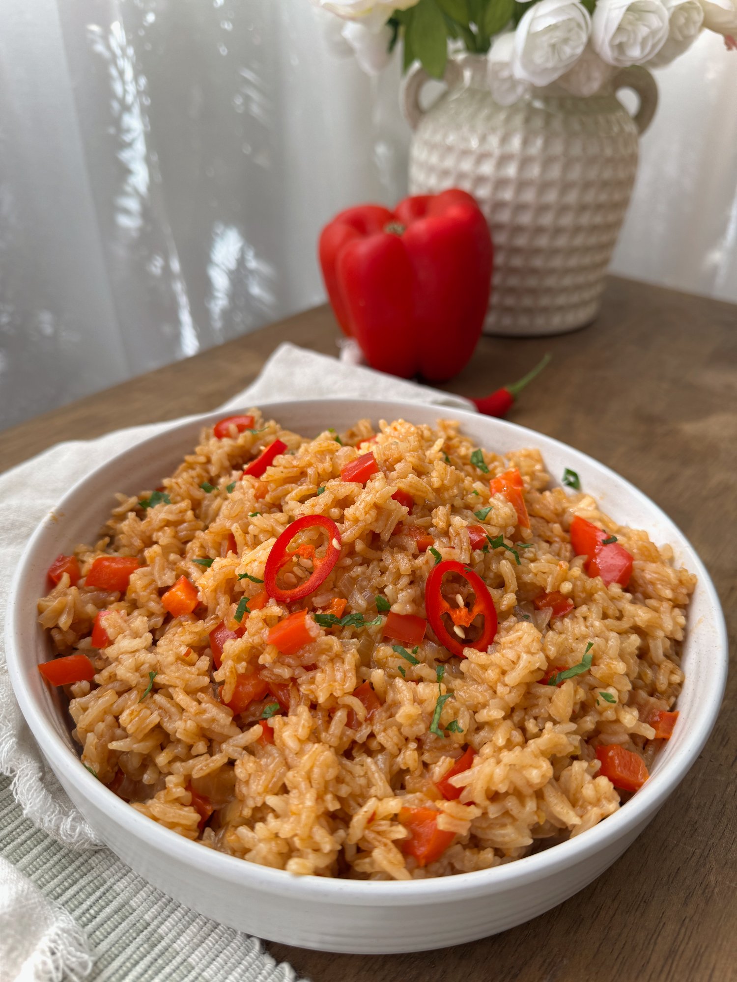 Vibrant peri-peri rice with garlic, paprika, capsicum, and tomato, in a bowl.