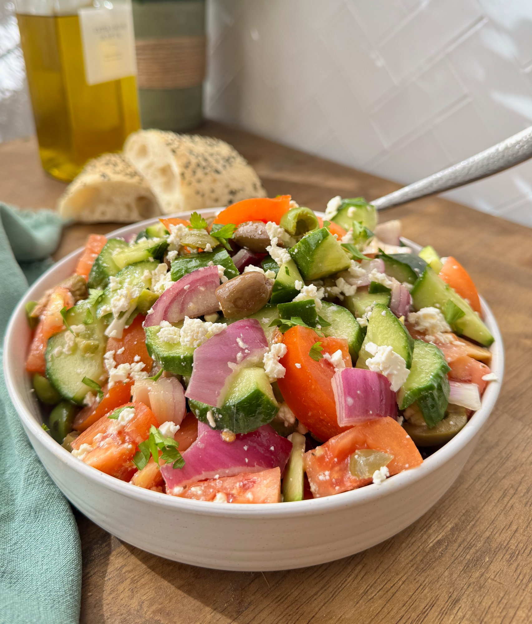 Fresh Greek-style salad with feta, olives, tomato, cucumber, and red onion.