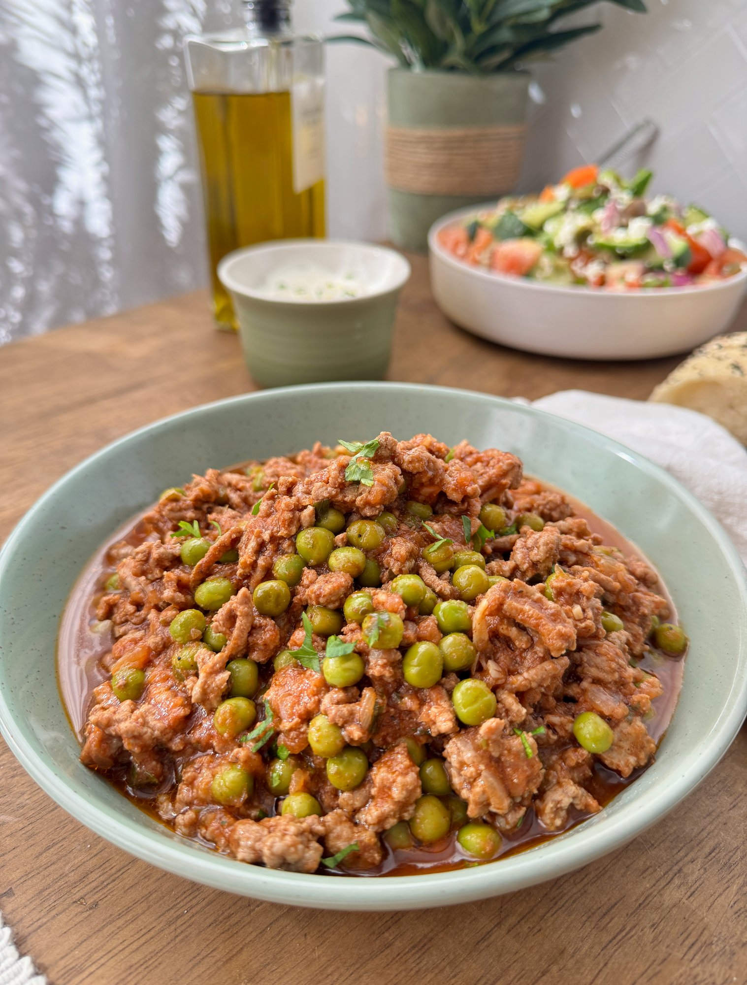 A bowl of saucy kofta-spiced lamb mince with peas and tomato.