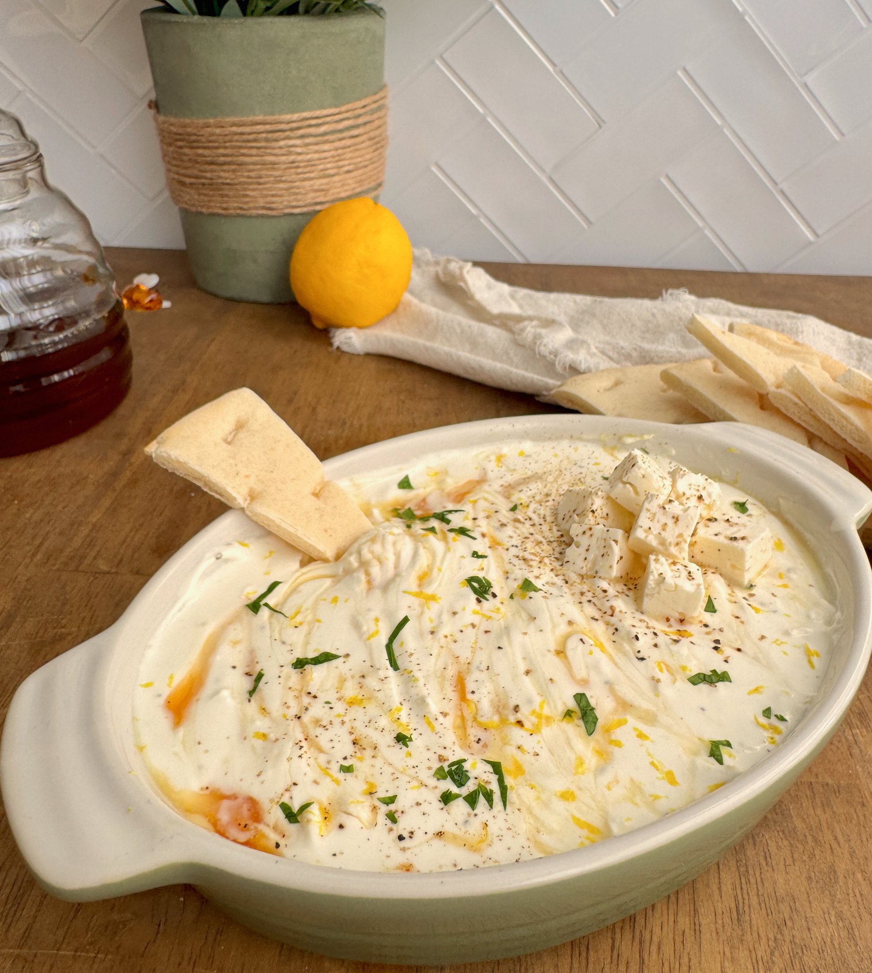 Whipped feta dip drizzled with honey and olive oil, finished with herbs and lemon zest.