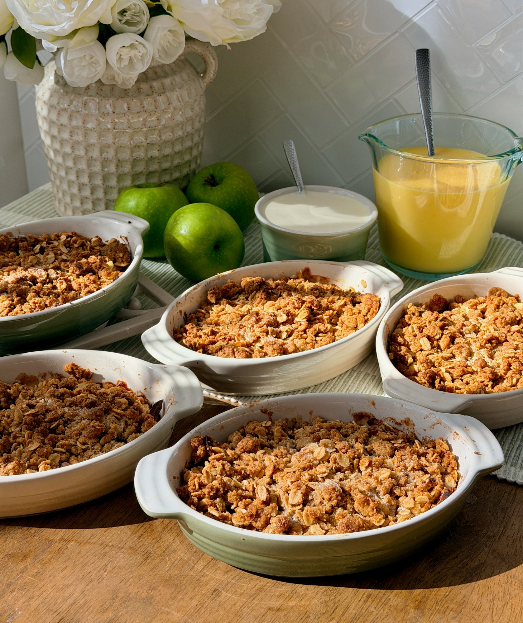 Individual green apple crumbles with a golden oat topping.