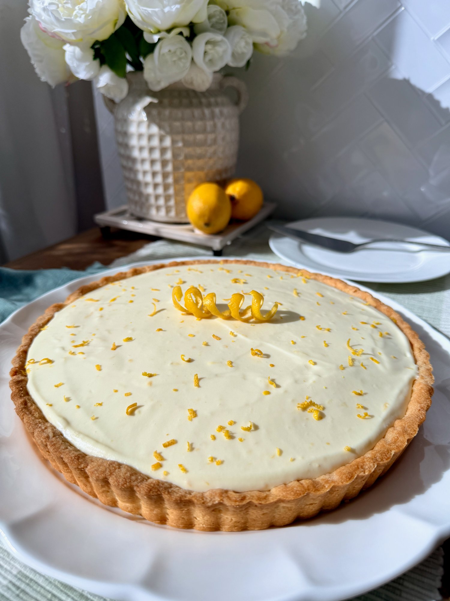 A no-bake lemon tart with a smooth, pale lemon filling on a shortbread base.