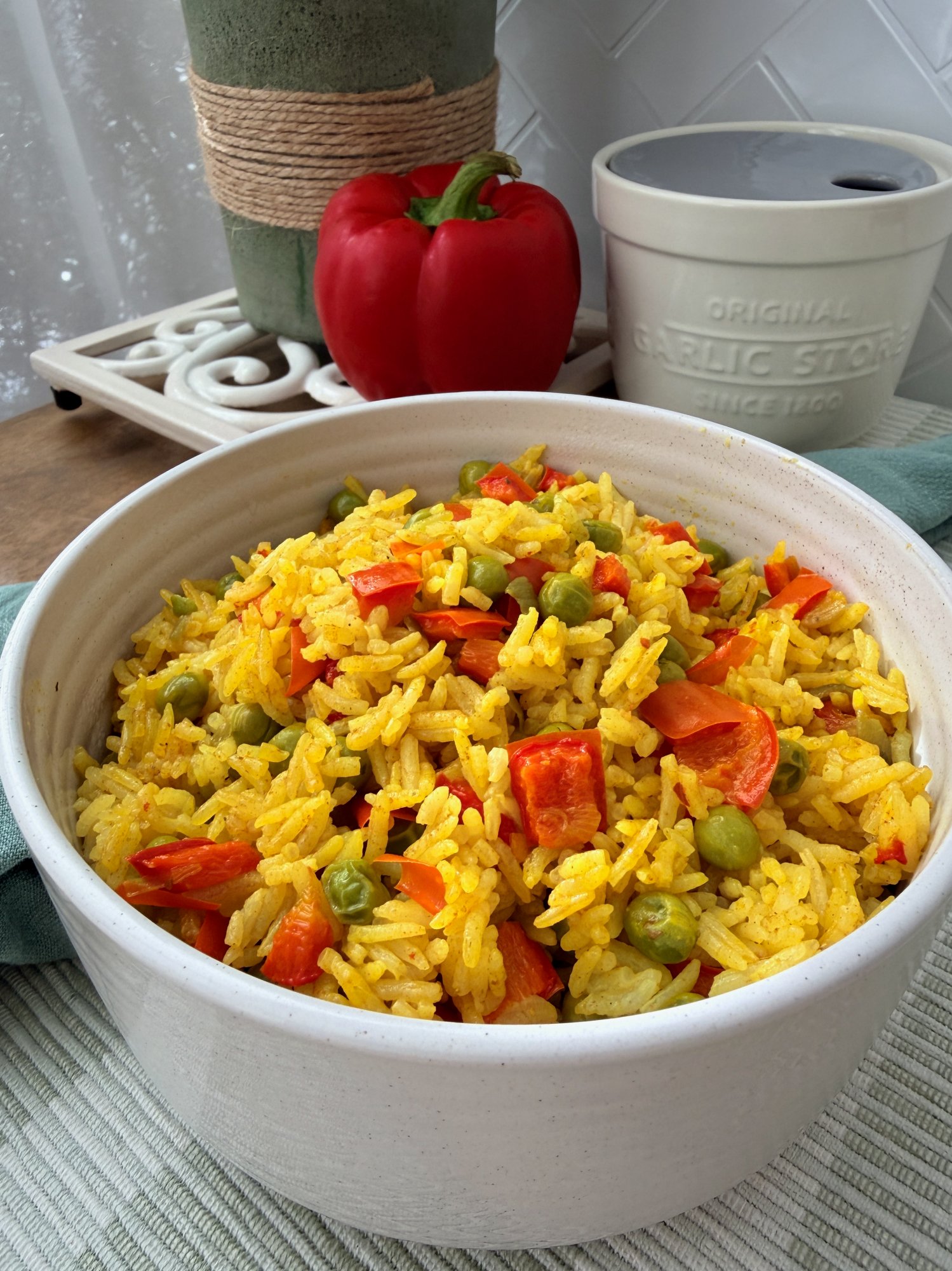 Golden Portuguese-style yellow rice with red capsicum and peas.
