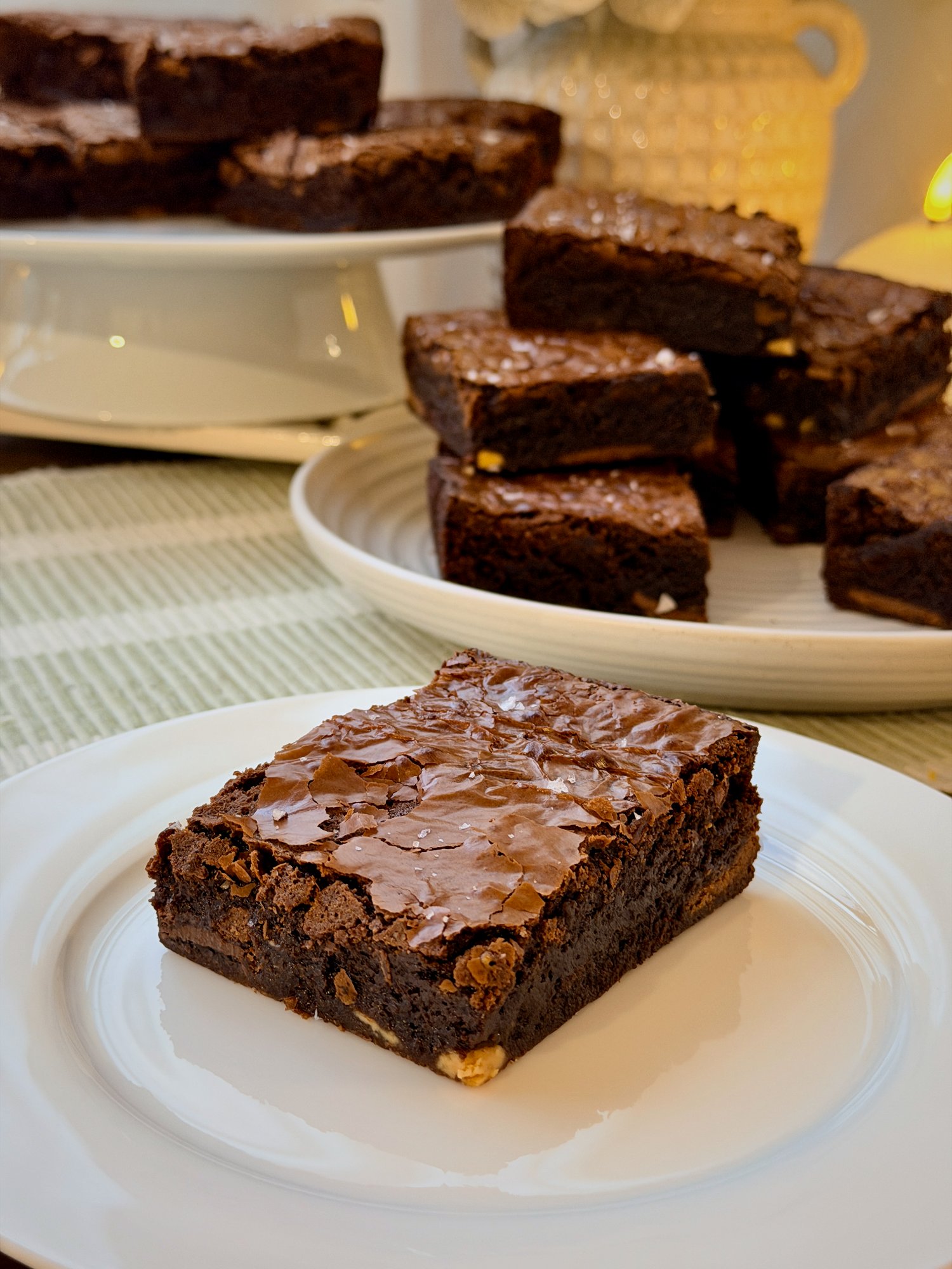 Fudgy chocolate brownies with glossy crackled tops and flaky salt.
