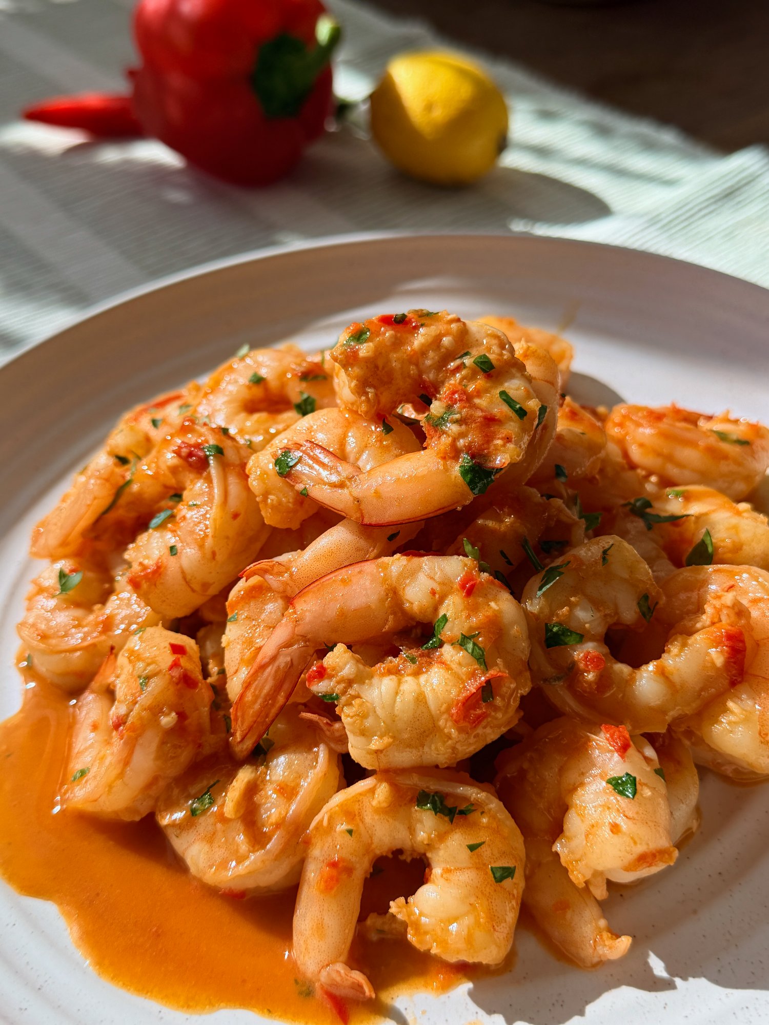 Portuguese pimenta prawns in a glossy red garlic and paprika butter sauce with lemon.