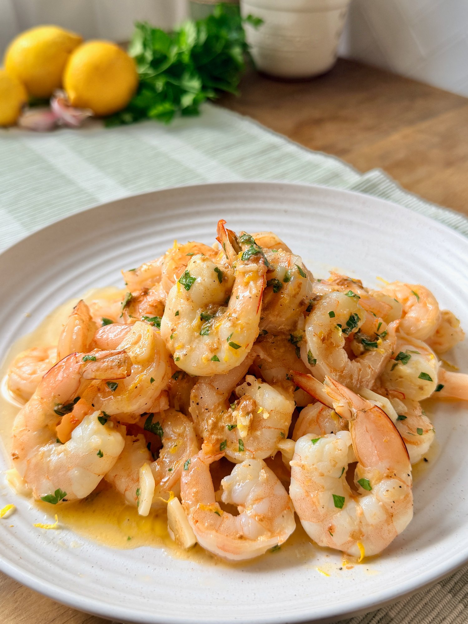 Garlic prawns in olive oil and butter with lemon and chopped parsley.