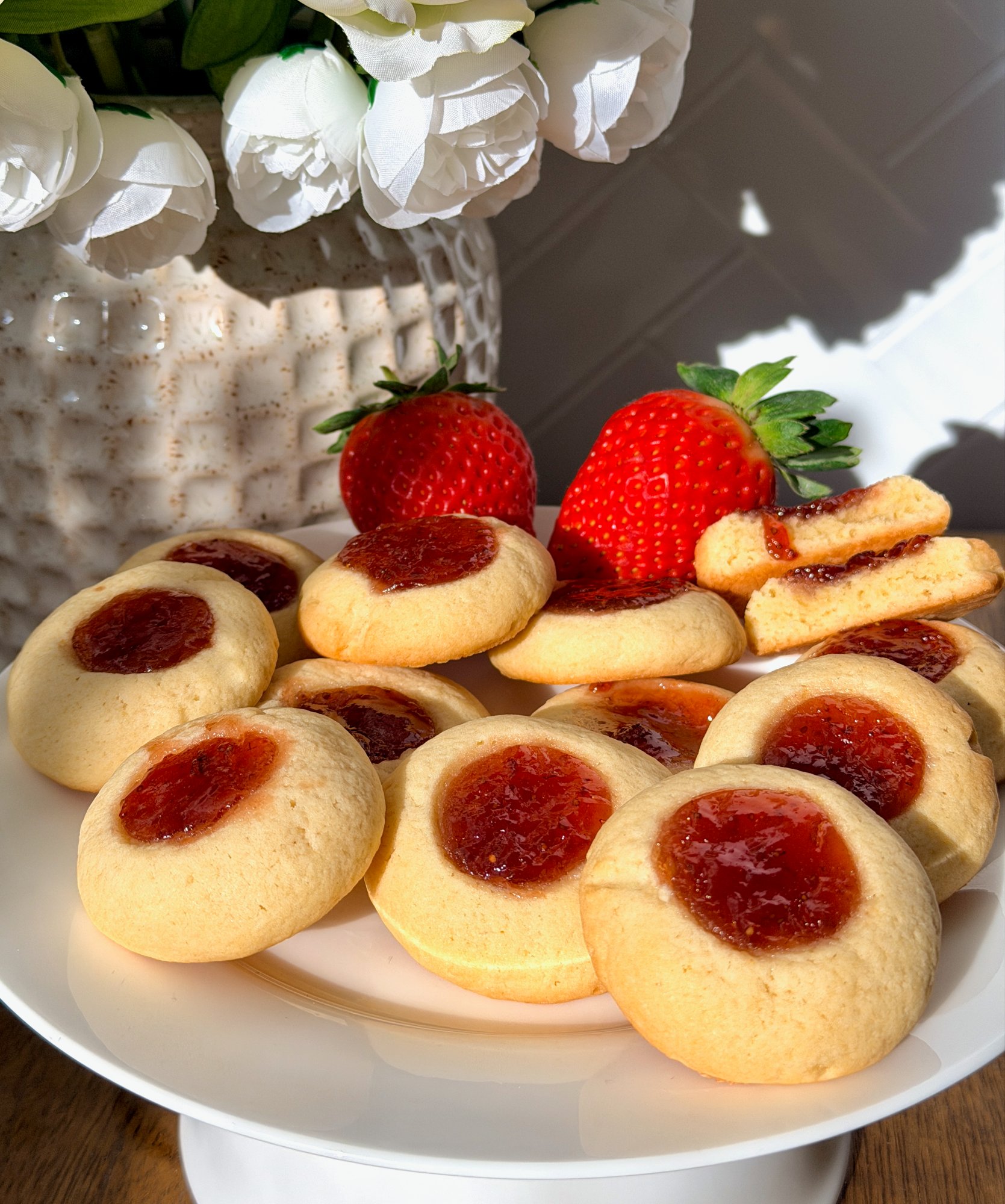 Classic jam drop biscuits with a spoonful of strawberry jam in the centre.