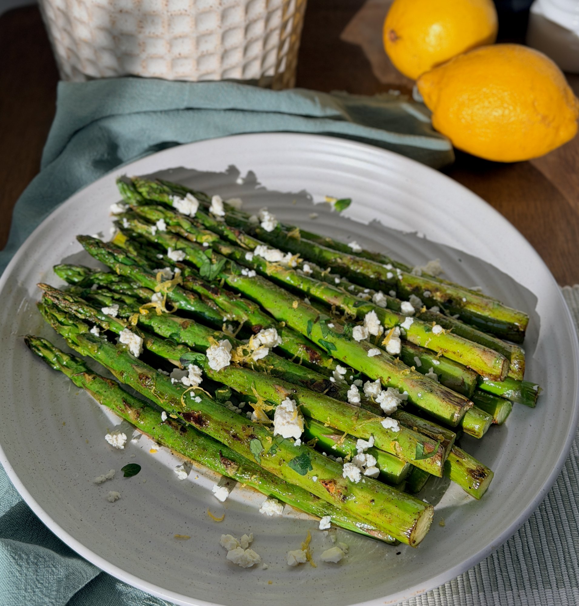 Charred asparagus topped with crumbled feta, lemon zest and parsley.