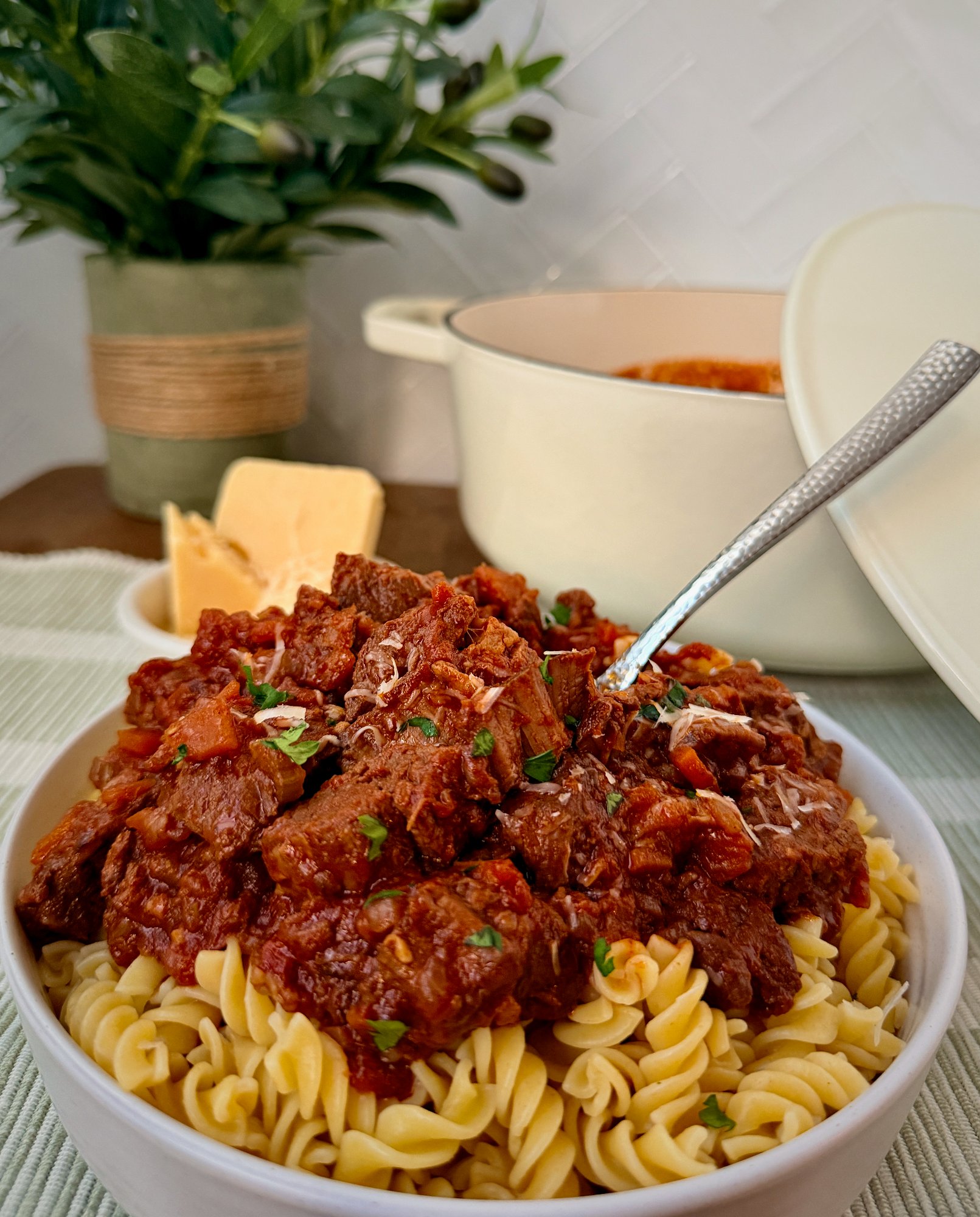 Slow-cooked shredded beef ragù in a rich red wine and tomato sauce over pasta.