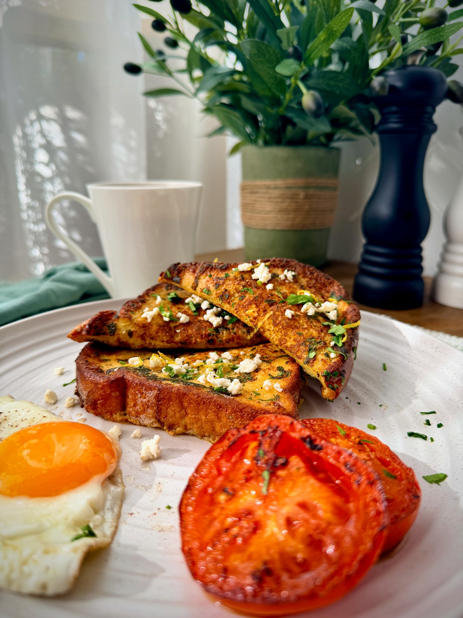Savoury brioche French toast with seared tomato, crumbled feta and a runny fried egg.