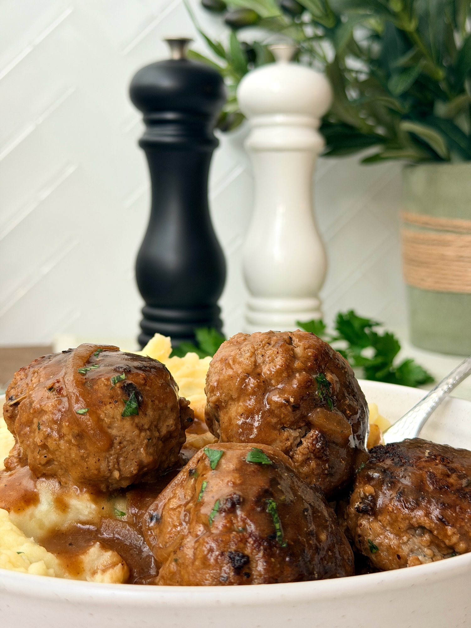 Beef rissoles in rich onion gravy with creamy herbed mashed potatoes.