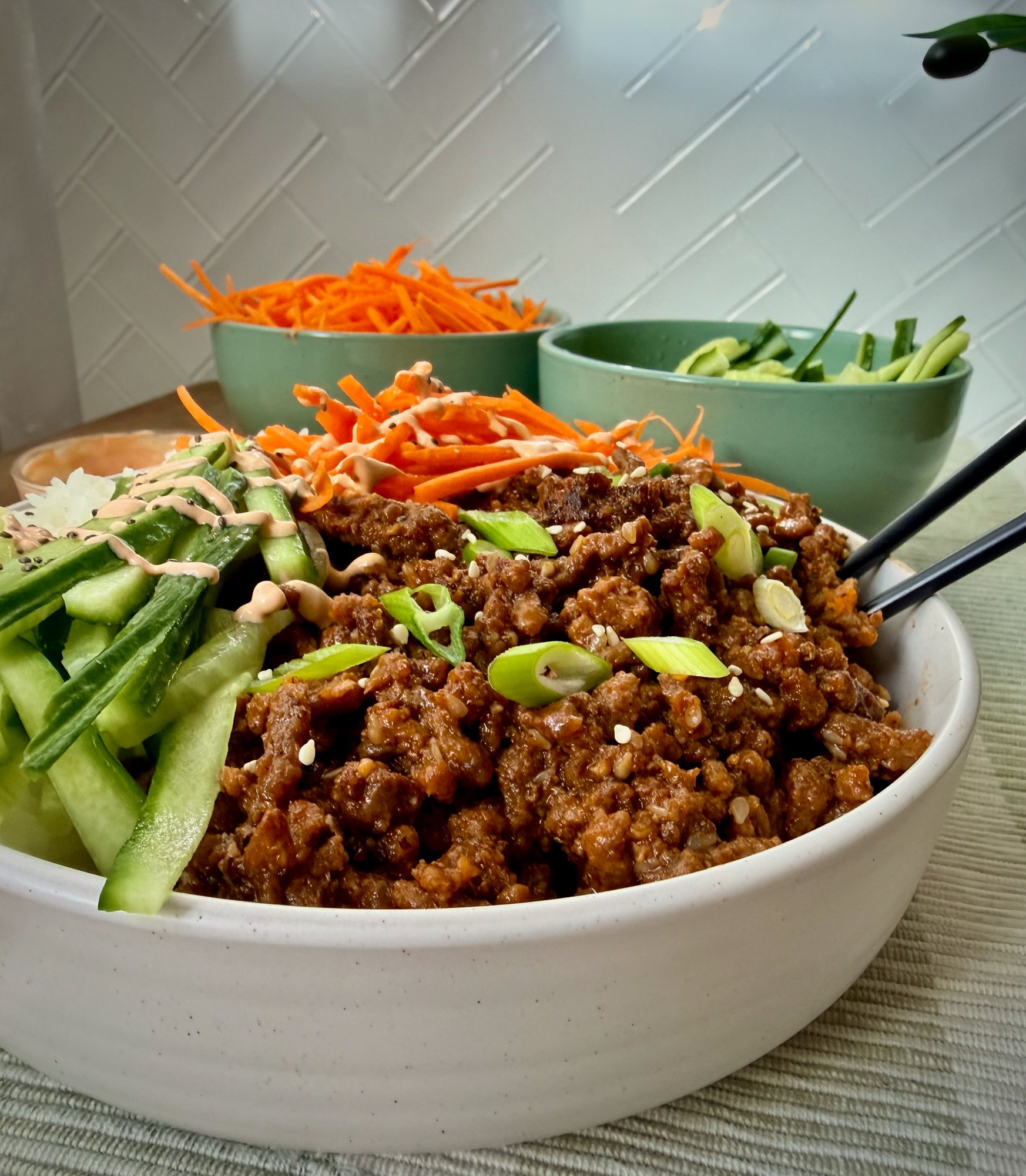 Korean beef rice bowls with gochujang beef mince, rice, carrot, cucumber and spicy mayo.