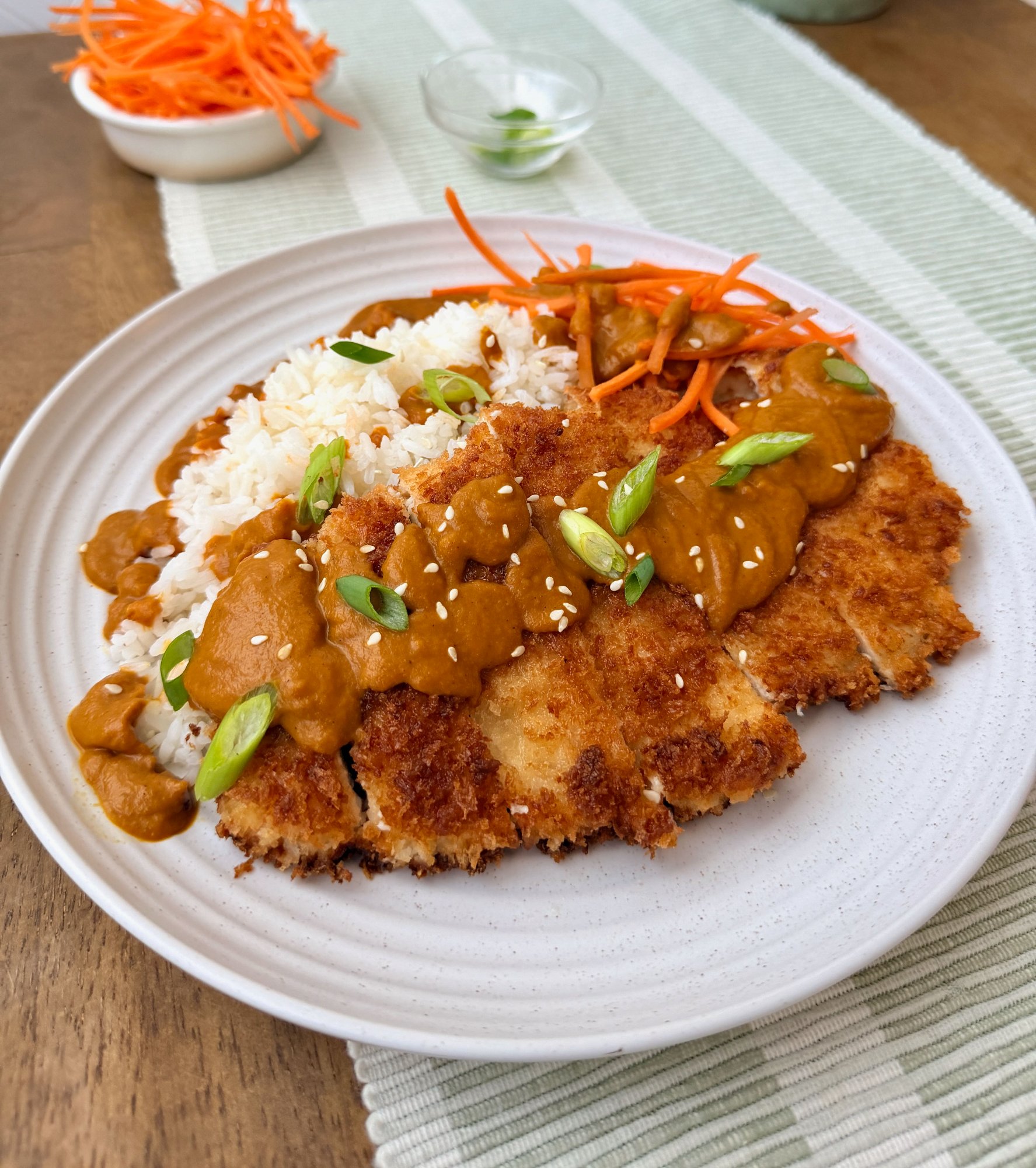 Crisp panko chicken katsu sliced over jasmine rice with golden curry sauce.