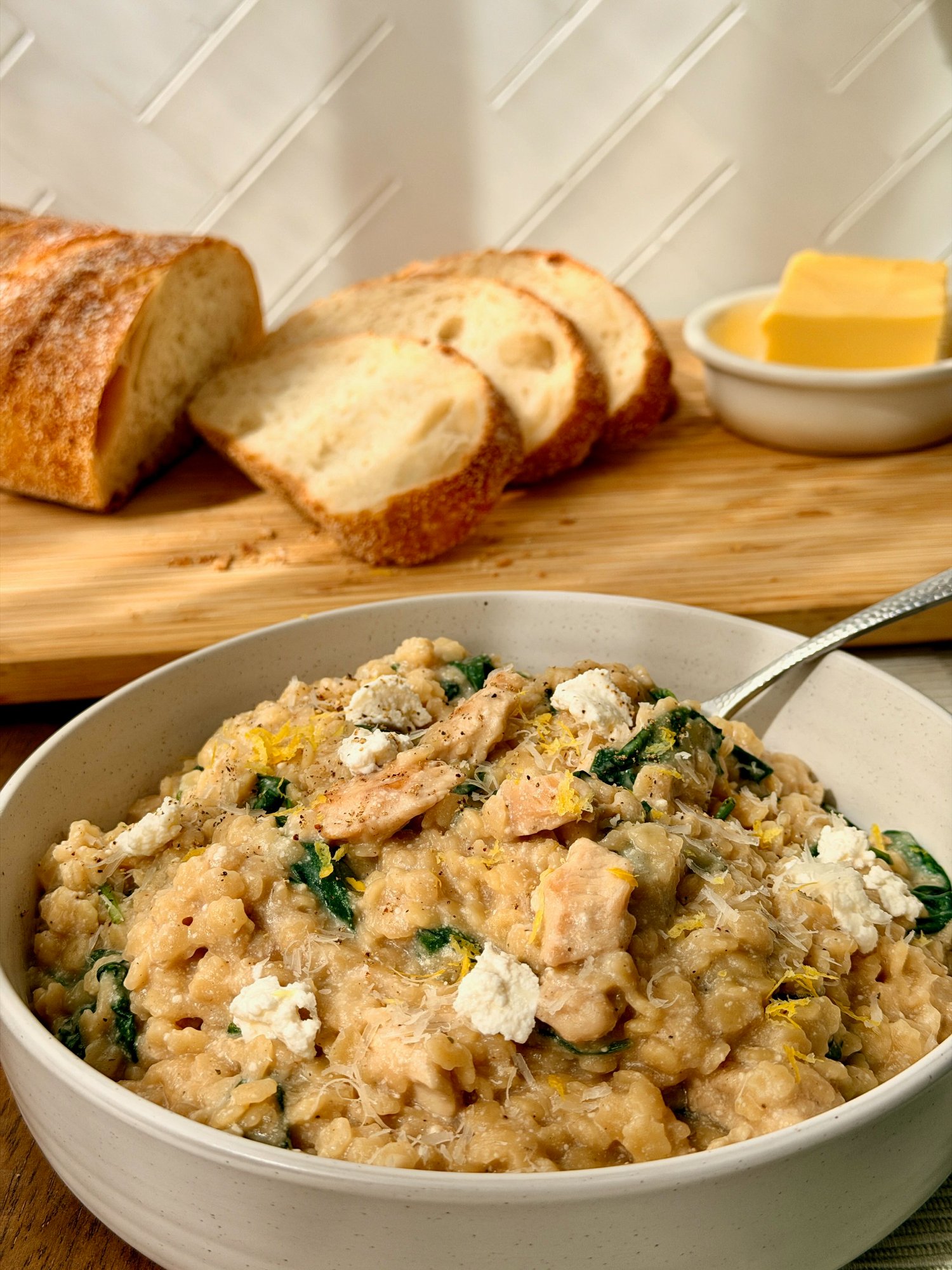 Creamy chicken and spinach star pasta with lemon zest and black pepper.