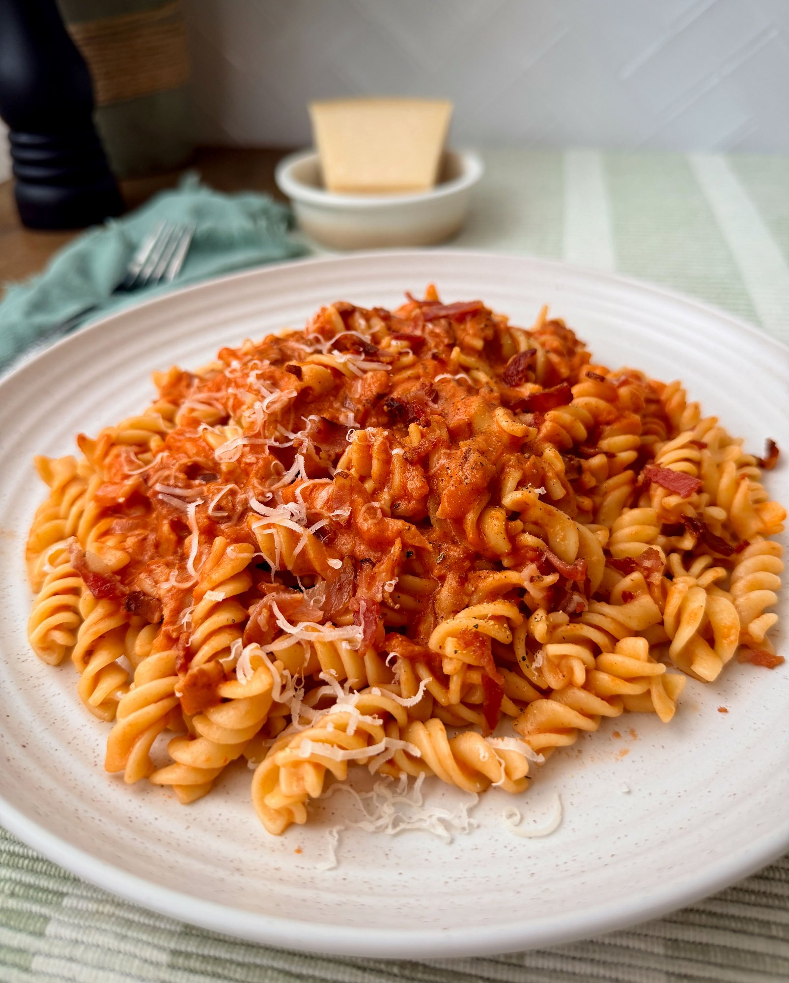 Short pasta in a creamy tomato vodka sauce with crisp pancetta and Parmesan.
