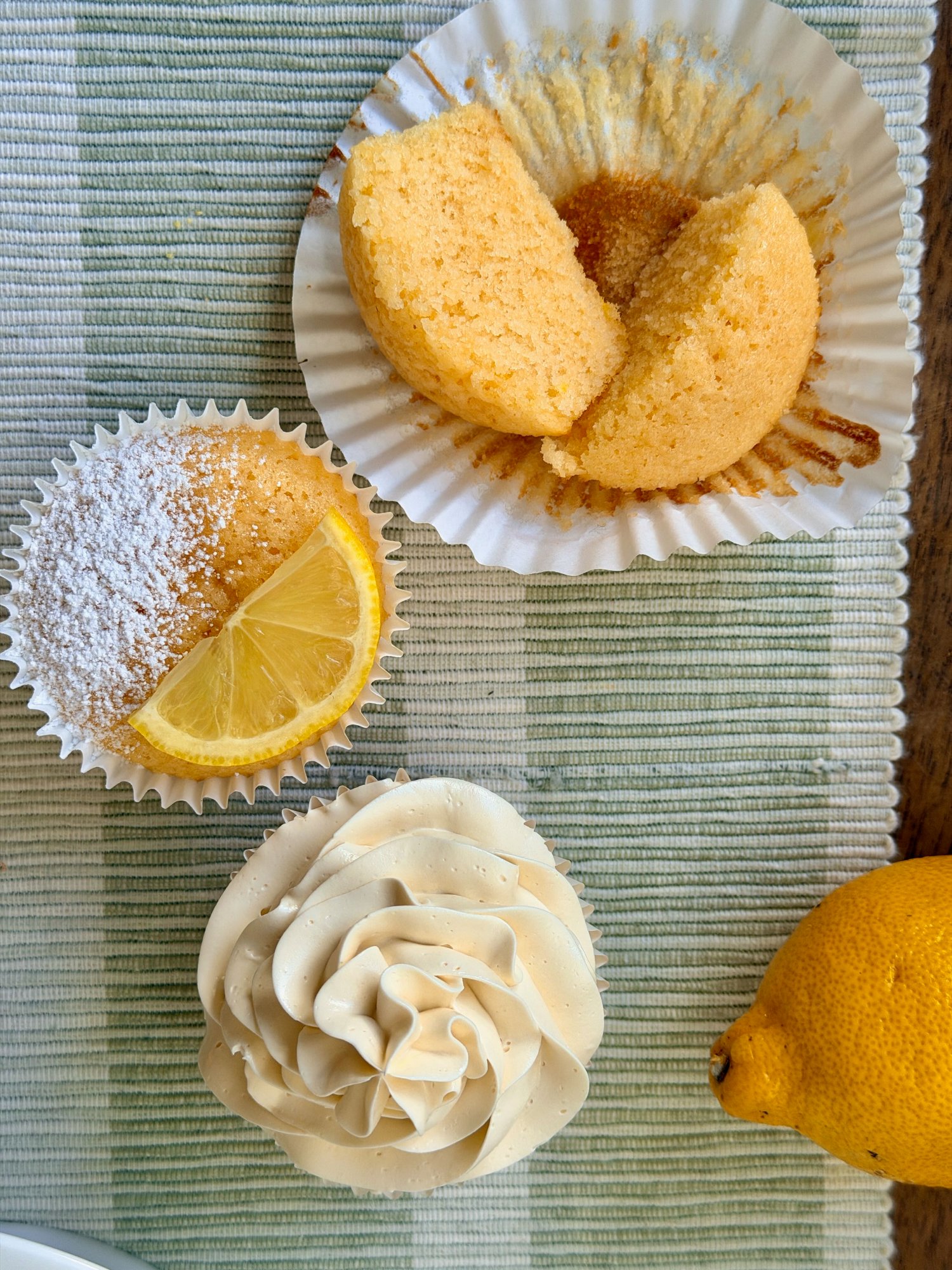 Lemon vanilla cupcakes topped with swirls of frosting.