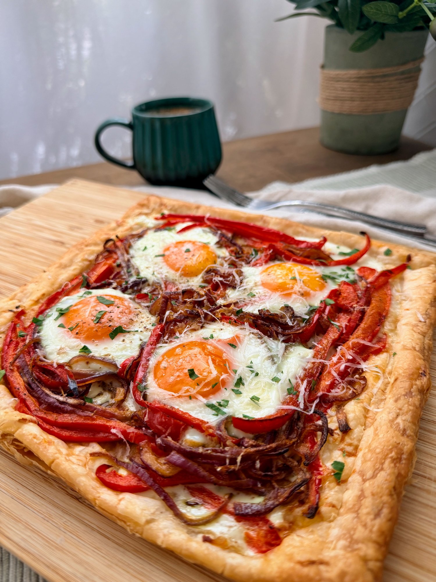 Puff pastry breakfast tart with roasted capsicum, red onion, pecorino and baked eggs.