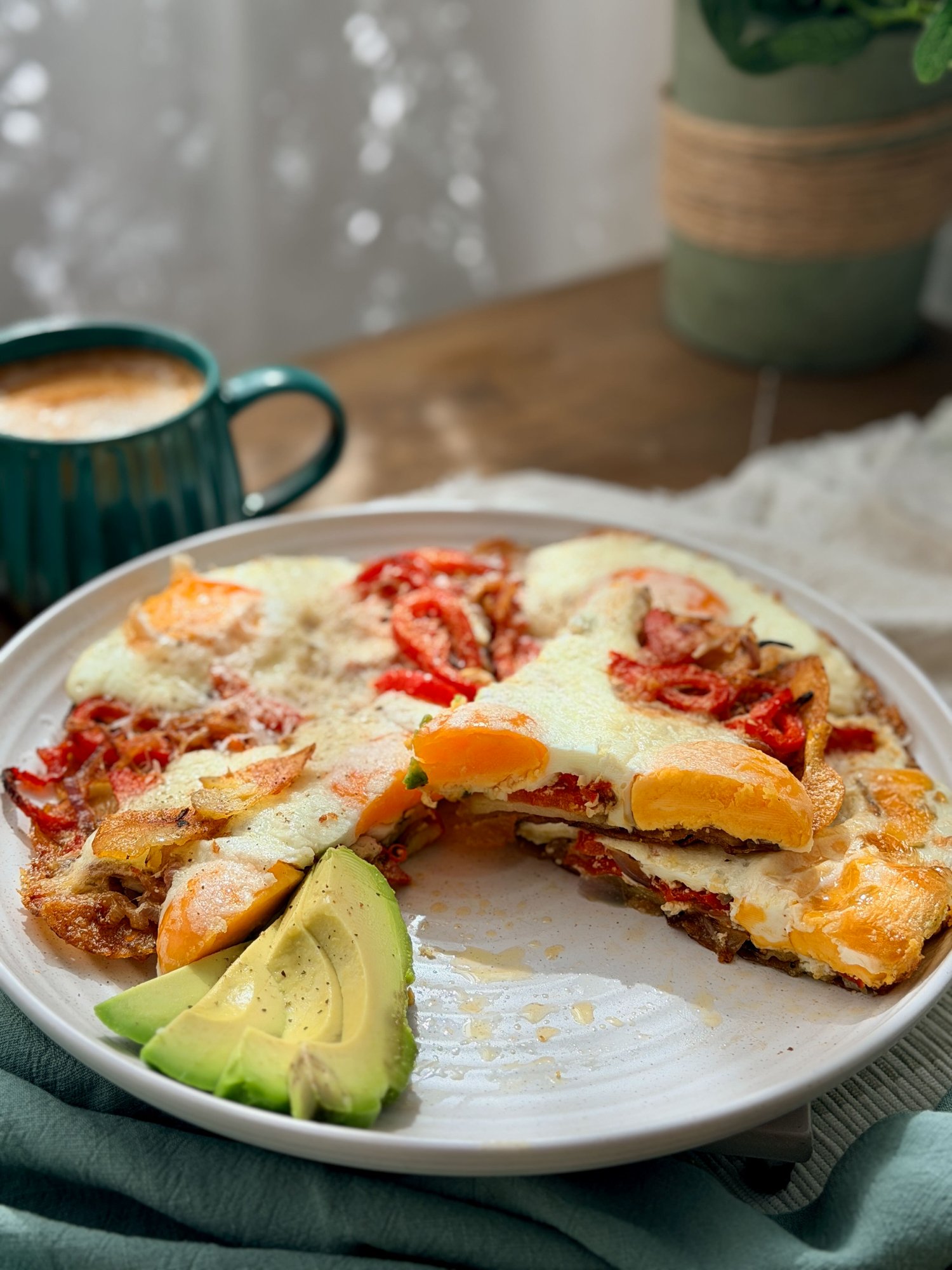 A breakfast skillet of crispy potato, capsicum and red onion with baked eggs and pecorino.