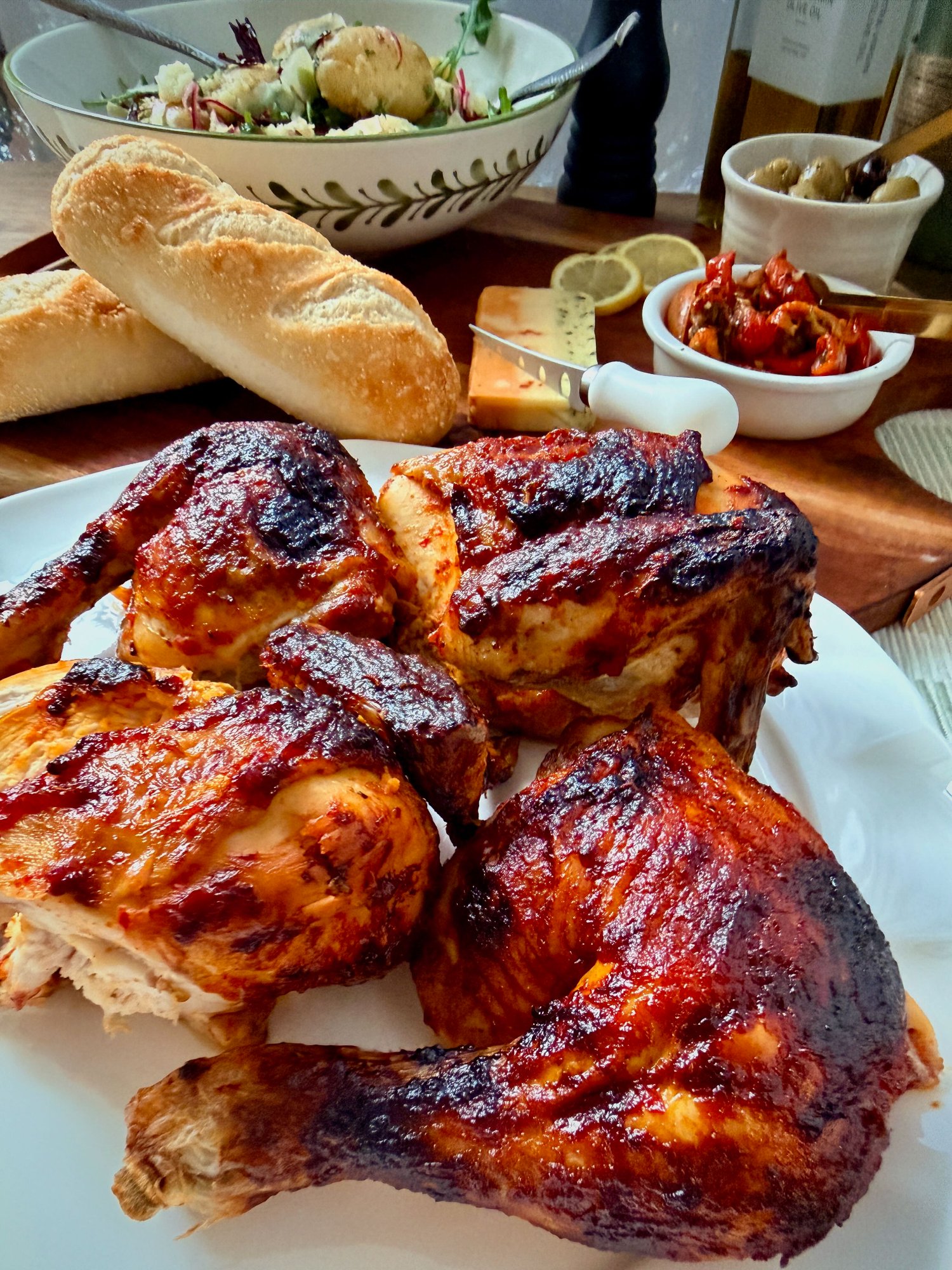 Butterflied peri peri roast chicken with a glossy, charred and caramelised red coating.
