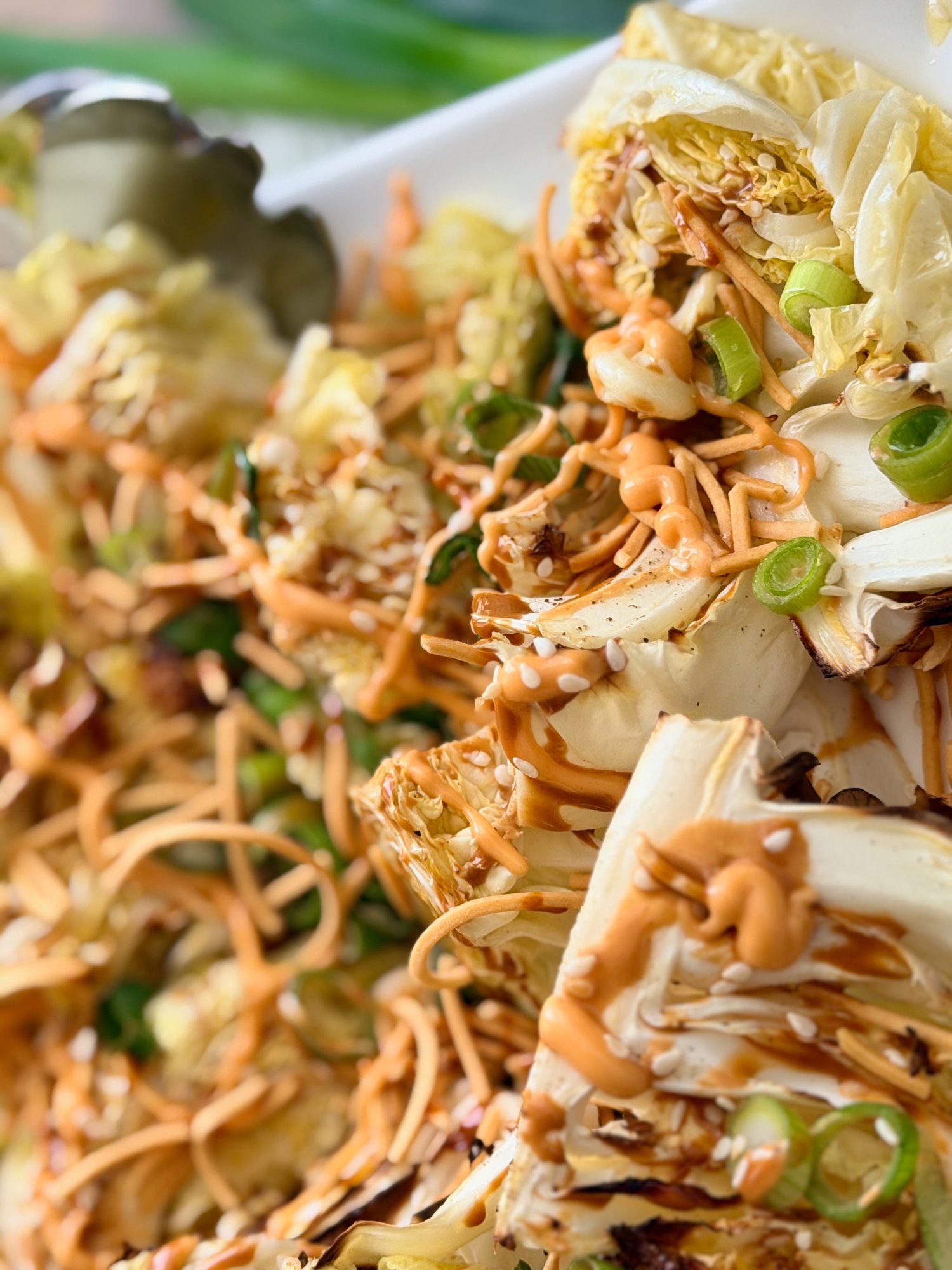 Bang bang roasted cabbage wedges with crispy fried noodles, spring onion, sesame seeds and a creamy chilli dressing.