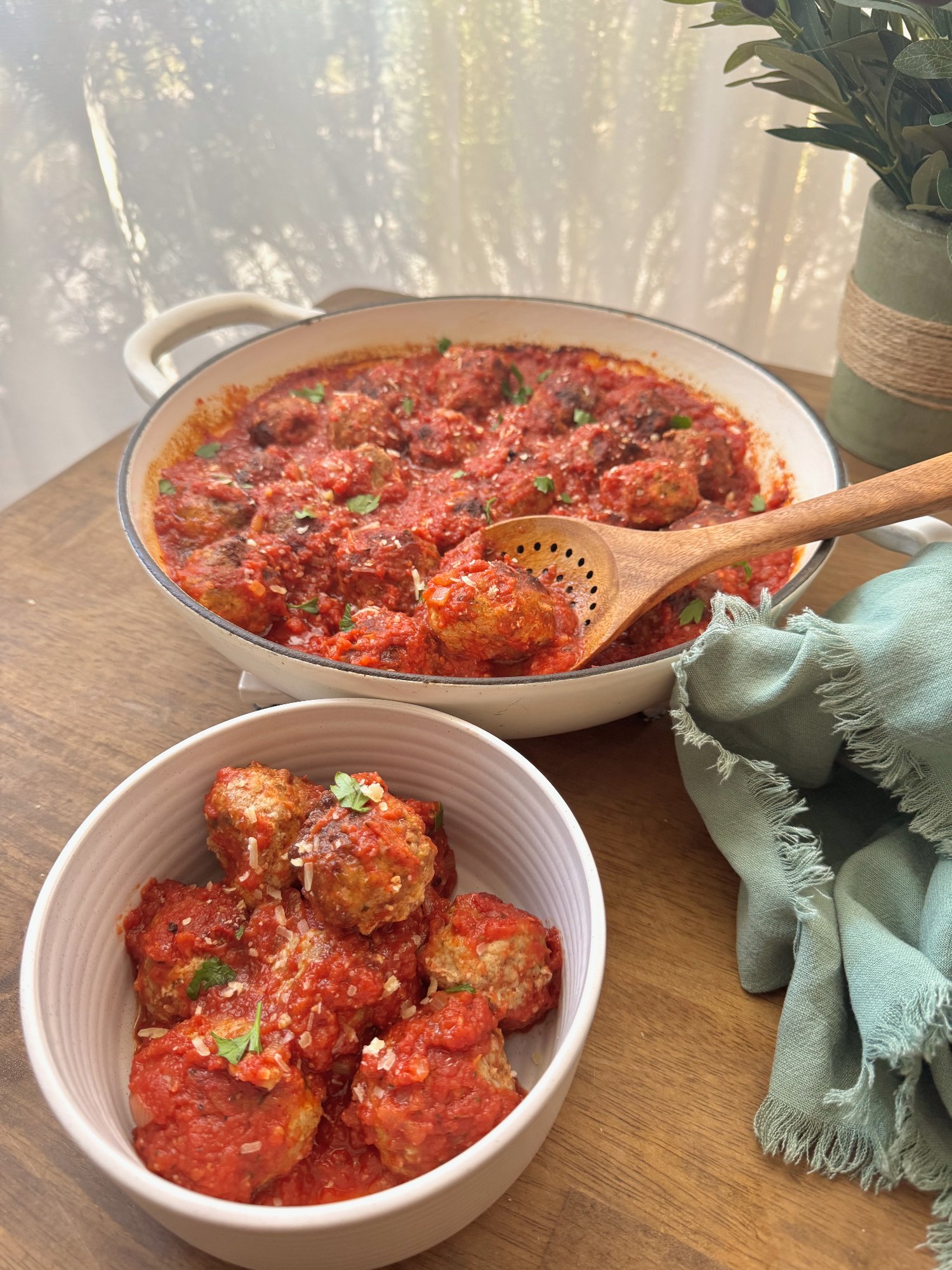 Beef and pork meatballs baked in a bubbling tomato sauce.