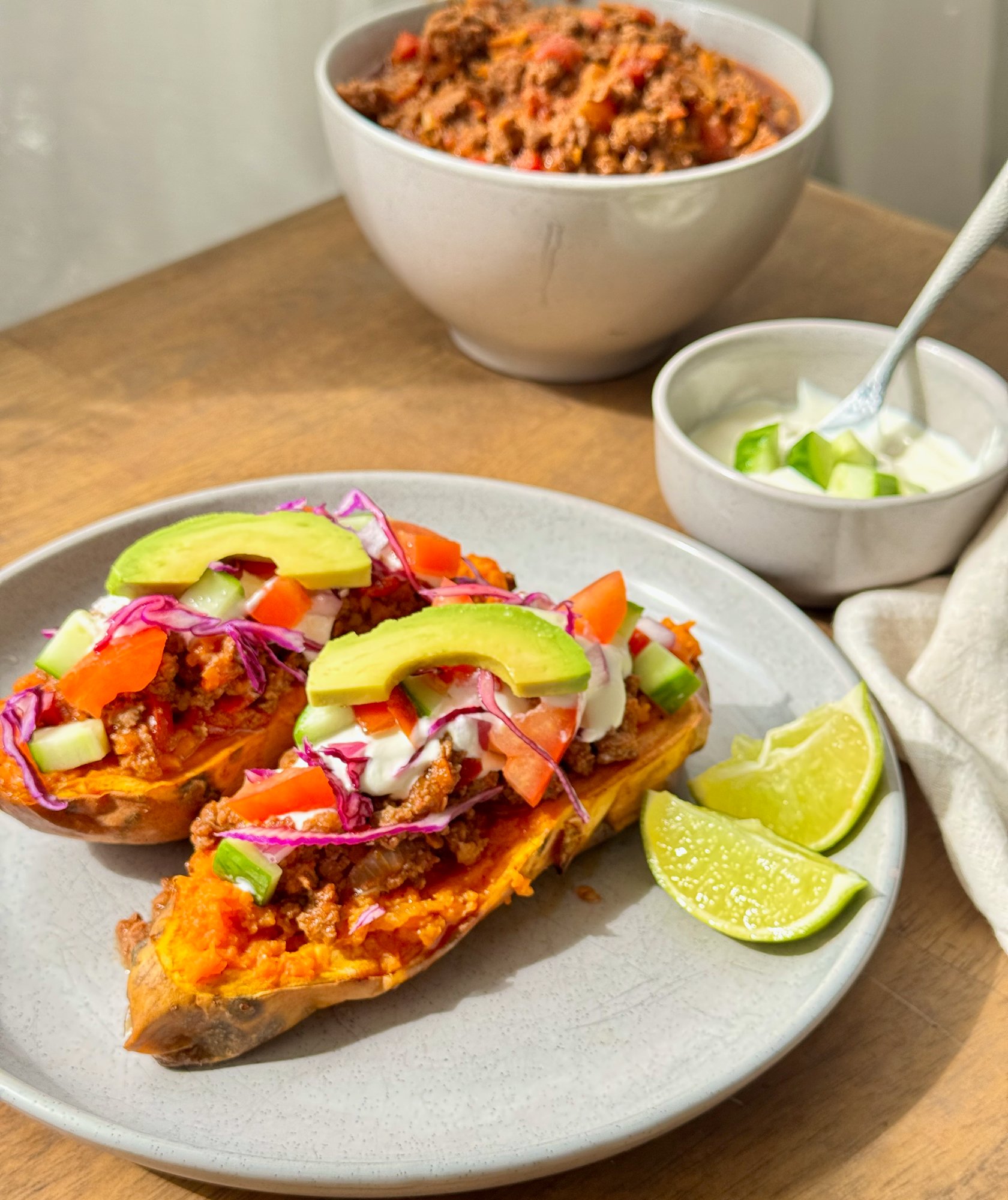 Roasted sweet potato halves filled with taco beef mince, Greek yoghurt, avocado, tomato and cucumber.