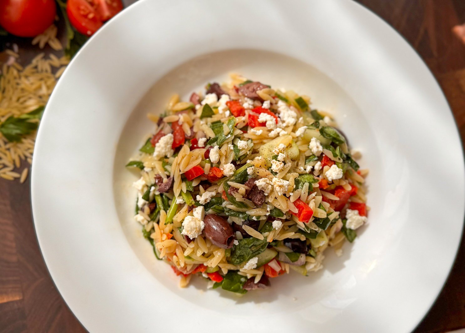 Vibrant Mediterranean risoni pasta salad with vegetables and feta.
