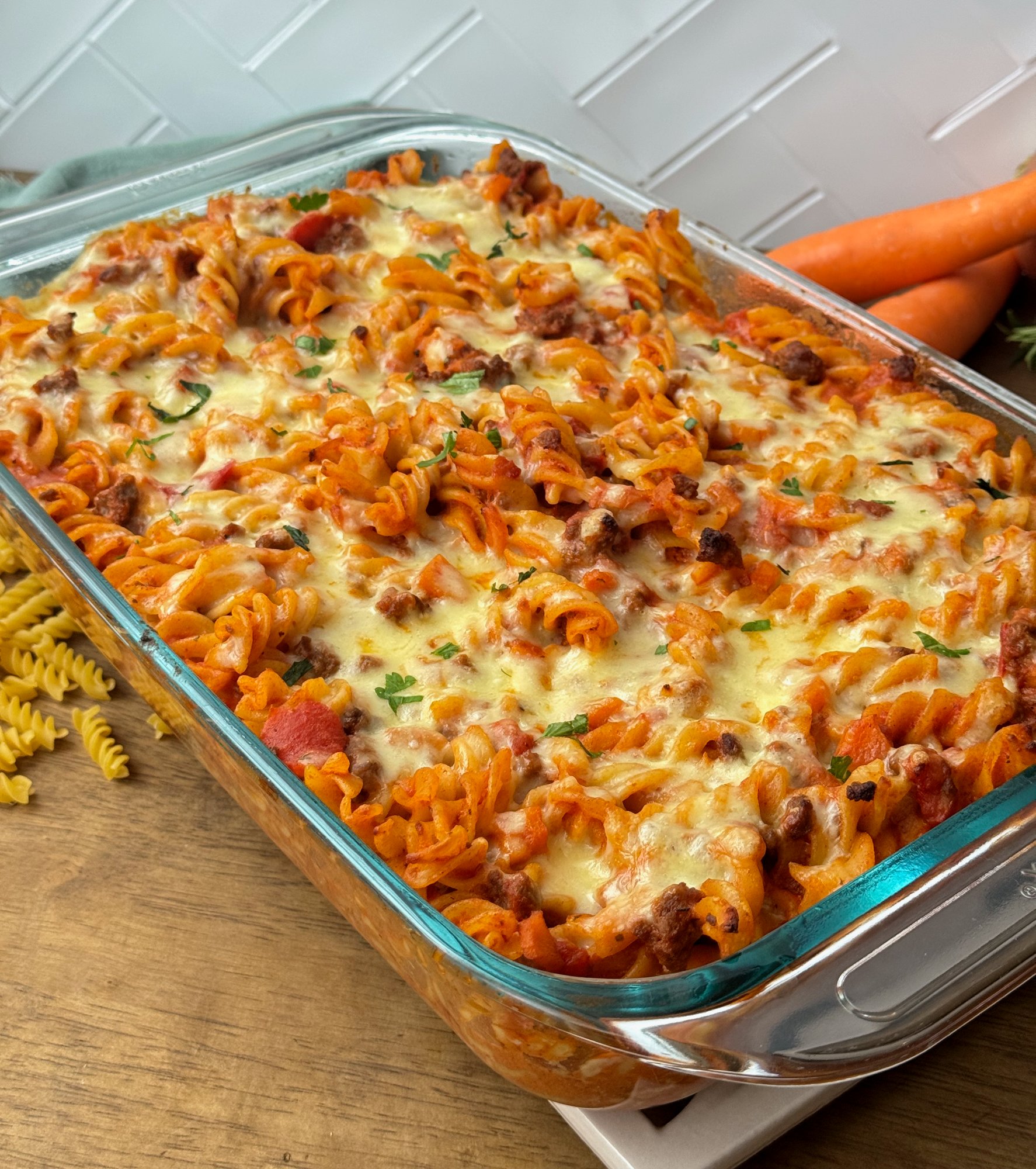 A family beef and tomato pasta bake served from the baking dish.